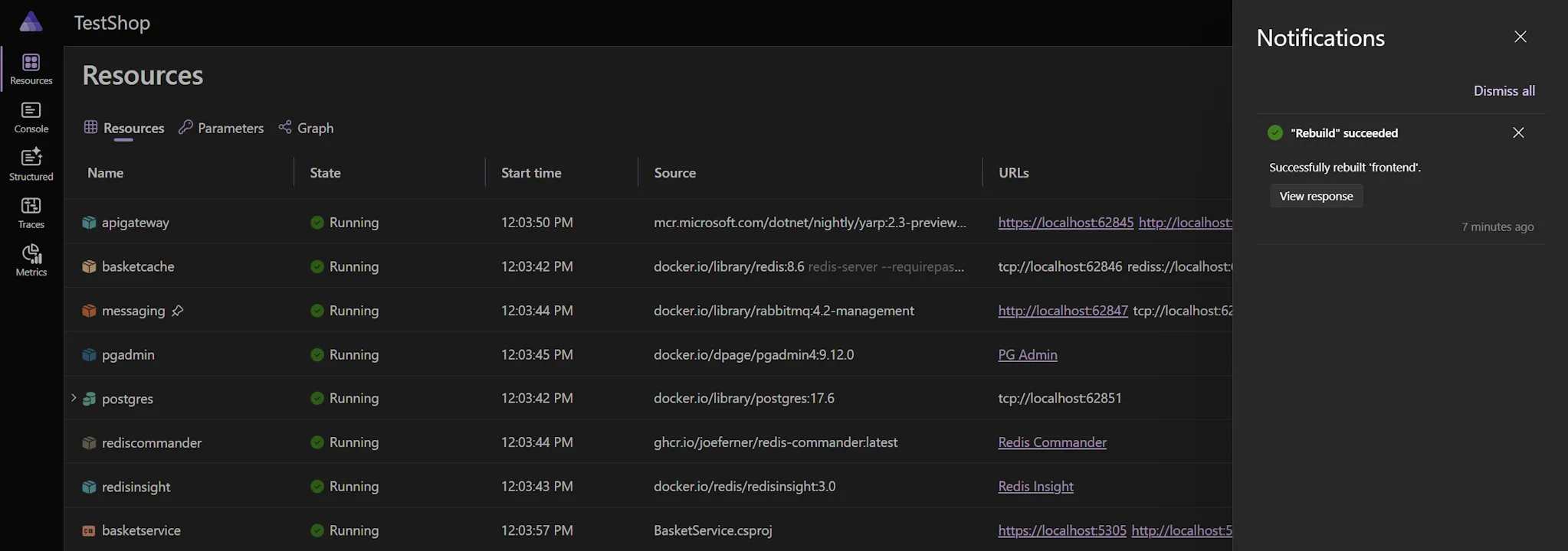 The Aspire dashboard notification panel open, showing a 'Rebuild succeeded' notification with a View response button